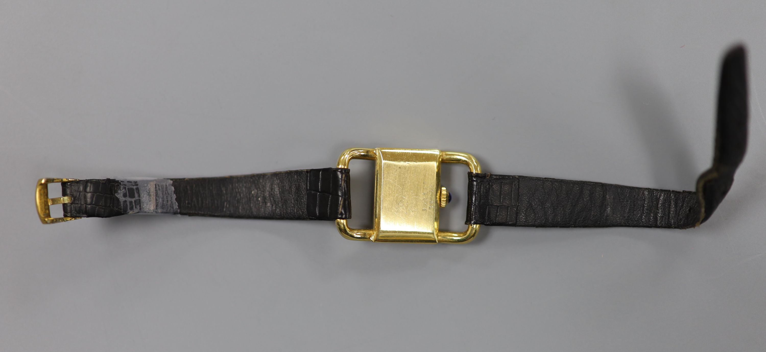 A ladys modern 750 yellow metal Baume & Mercier manual wind rectangular dress wrist watch, on a leather strap (strap a.f.),